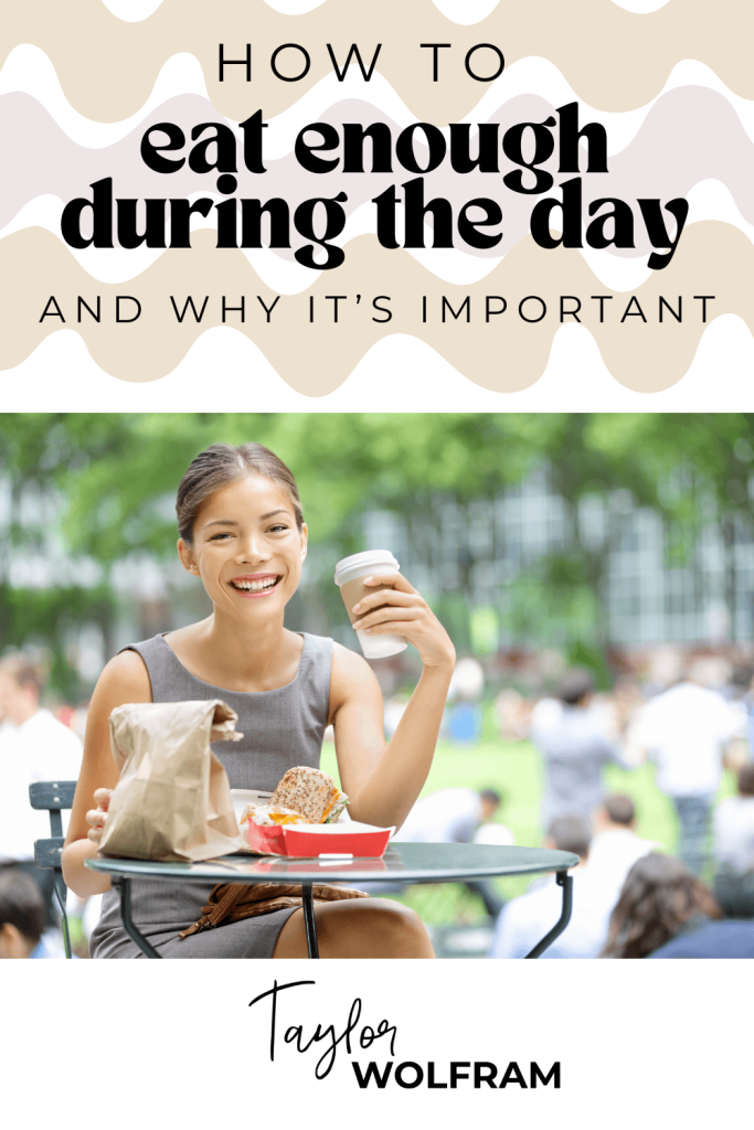 a young woman is sitting outside holding a cup with a brown bag lunch on the table in front of her
